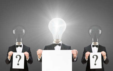 Half-length portrait of three businessmen with bulbs instead of heads keeping question marks and...