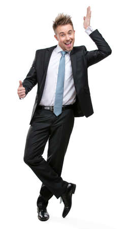 Full-length portrait of businessman setting against something who wears suit with blue tie, isolatedの写真素材