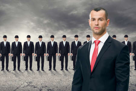 Serious  business man standing in front of his teamの写真素材