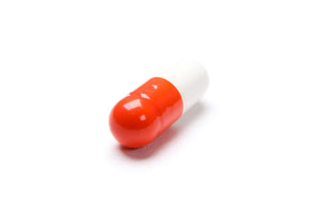 Vitamins red capsule, isolated on white. Healthcare concept.の写真素材