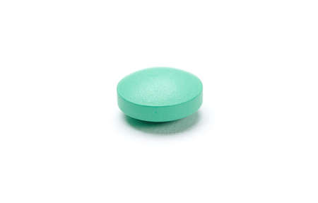 Green pill, isolated on white. Healthcare concept.の写真素材