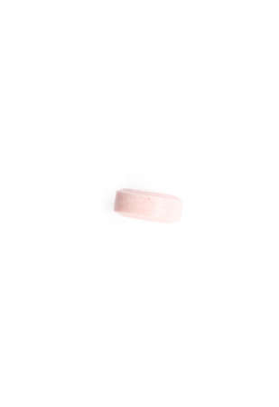 Pink tablet, isolated on white. Healthcare concept.の写真素材