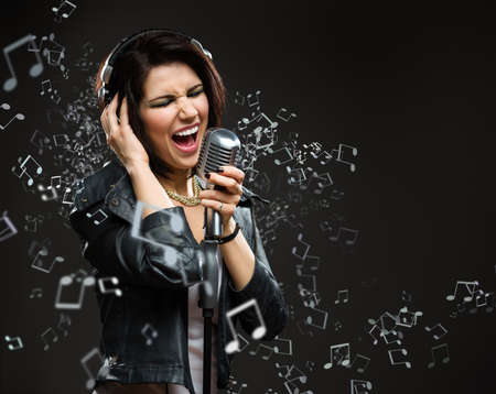 Singing song rock musician with microphone and earphones. Concept of rock music and rave
