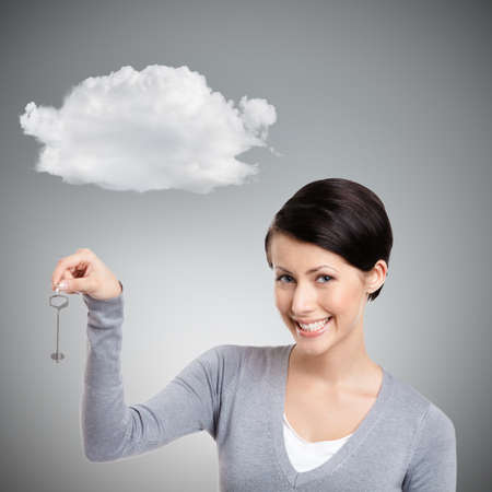 Girl hands a silver key, isolated on grey background with cloud