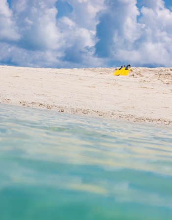 Yellow flippers for swimming on the beach, Maldivian island
