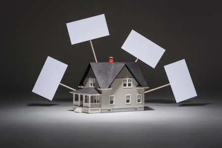 Realty concept - house architectural model on grey backgroundの写真素材
