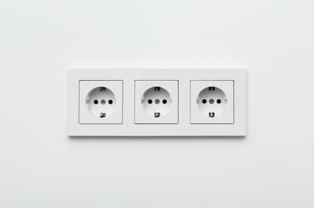 Set of three sockets on the white wall