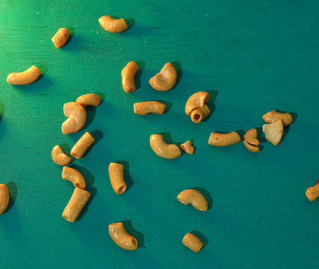 Fried macaroni on turquoise background.  Spicy dry macaroni, flat layの写真素材