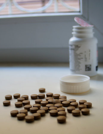 vitamins scattered. against their background is a jar of vitaminsの写真素材