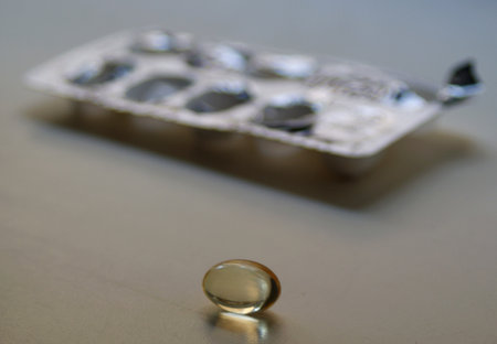transparent capsule on the background of packaging with pillsの写真素材