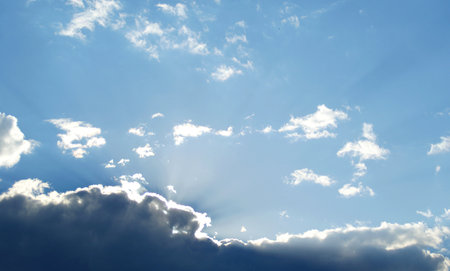 the sun is slowly coming out from behind the cloudsの写真素材