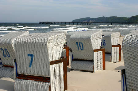 White, numbered beach chairs on the beachのeditorial素材