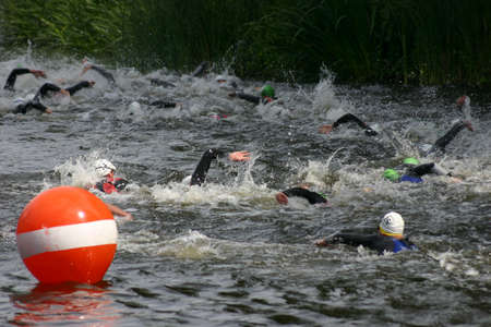 Swimmers in the triathlon in a canal in Potsdamのeditorial素材