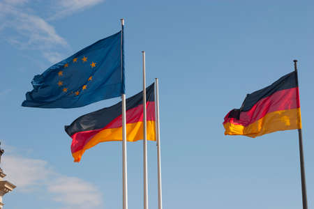 German and European flags in front of the Reichstagの写真素材