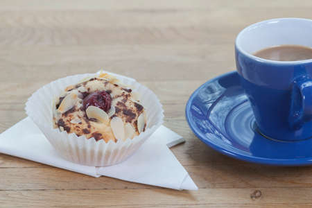 Cherry Tart in Papierervieltte with a cup of coffeeの写真素材