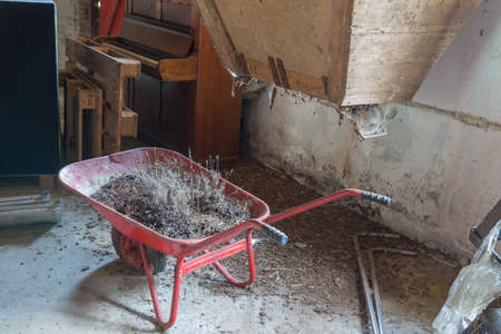 Old wheelbarrow in an abandoned pigsty in Tryggelev, Denmarkの写真素材