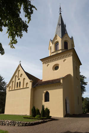 Yellow church in TranekÃ¦r with side lightの写真素材