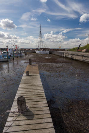 Narrow Jetty in the small harbor still, Langelandのeditorial素材