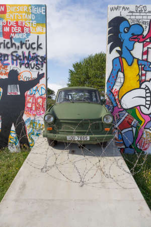 Trabant on a ramp between the wall parts and barbed wireのeditorial素材