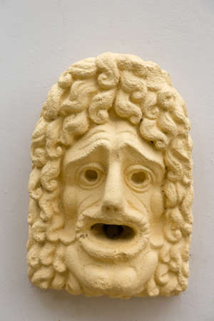 Yellow mask on a fountainの写真素材