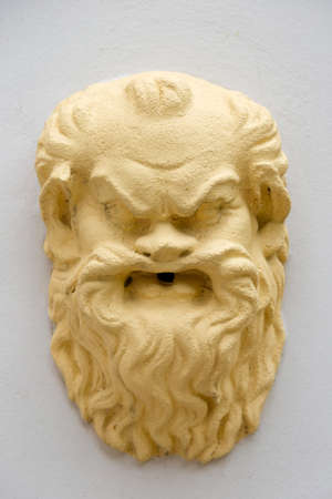 Yellow mask on a fountainの写真素材