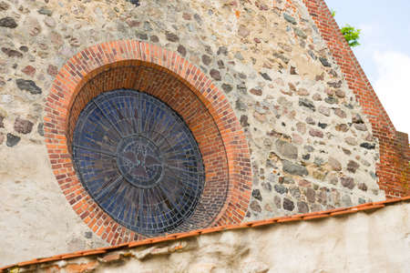 Round church window at a small churchの写真素材