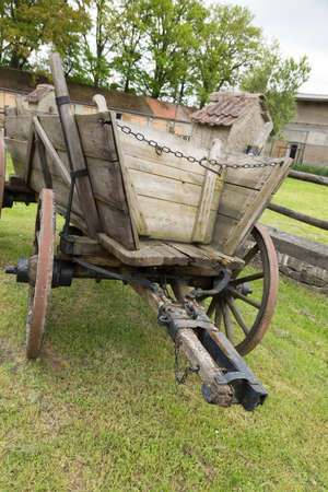 Old, wooden horse-drawn carriage with drawbar