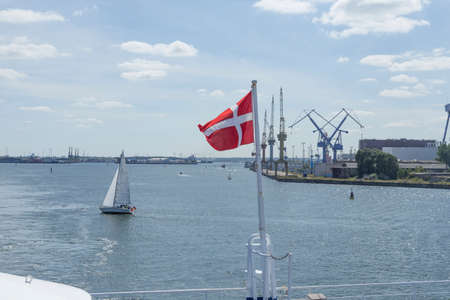 Danish national flag at the stern of a ferryの写真素材