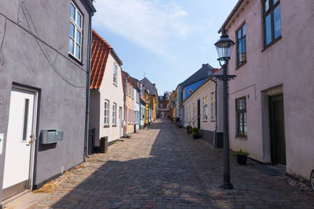 Narrow alley with lantern in downtown Nykbing Falster Denmarkの写真素材