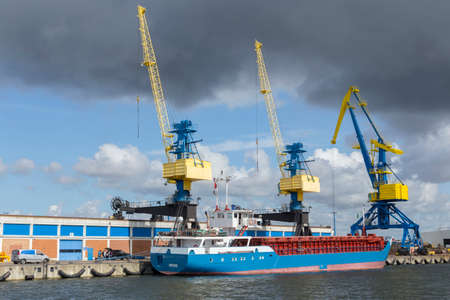 Three large industrial cranes in the port of Wismar Mecklenburg-Vorpommern