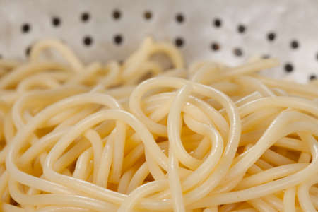 Spaghetti very close in a strainerの写真素材