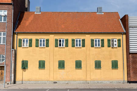 Yellow painted building in the port of Nakskov Lolland Denmarkの写真素材