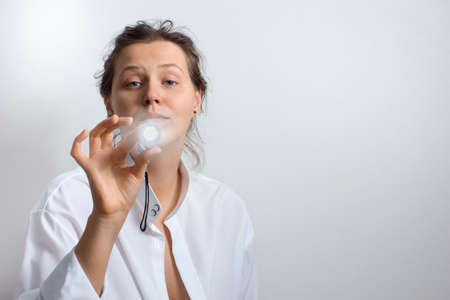 A young woman with flashlight  in the right hand.の写真素材