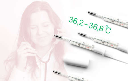 Four mercury thermometers showing a normal human temperature. A girl with a stethoscope in a...