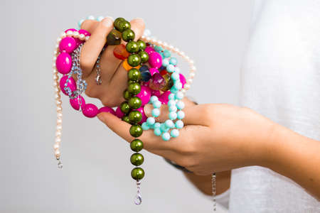 Young womans hands with jewellery, beads.の写真素材