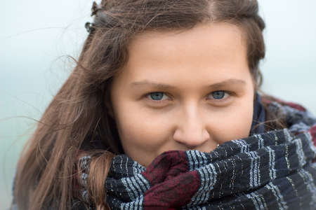 Smiling girl with a big scarfの写真素材