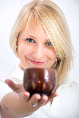 Portrait of young woman with a clay glaze cupの写真素材