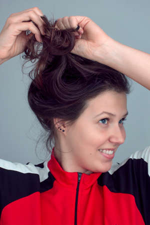 Portrait of a girl preening own hairの写真素材