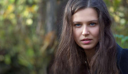 Portrait of girl in autumn forestの写真素材