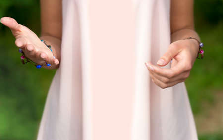 Girls hands and her pink dressの写真素材