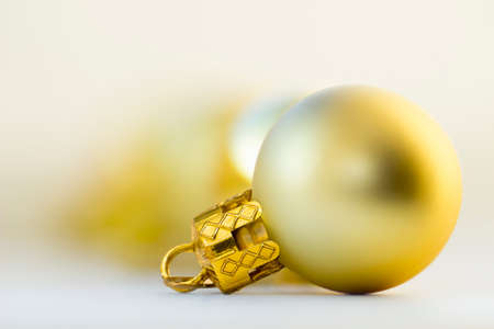 Golden Christmas toy ball in a blurred backgroundの写真素材