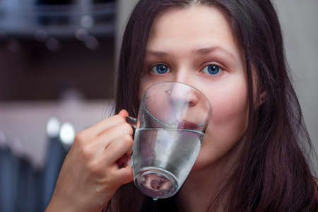Portrait of a girl with a glass of water