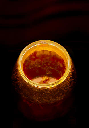 Close view of rim of the jar with crystallized honey in a dark backgroundの写真素材