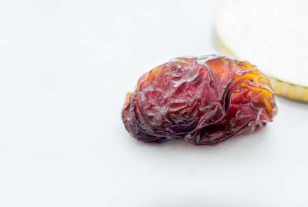 Close view of  sun dried raisin in a white backgroundの写真素材