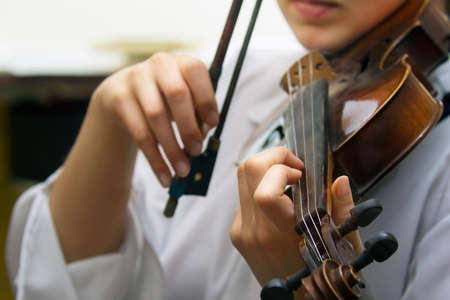 Close view of girls hand on  violins stringsの写真素材