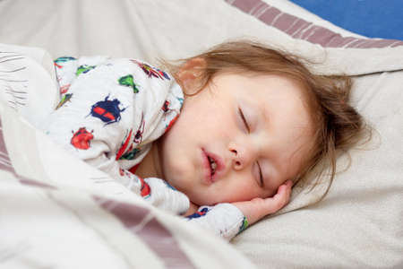 Sleeping sick little  girl in  a bed