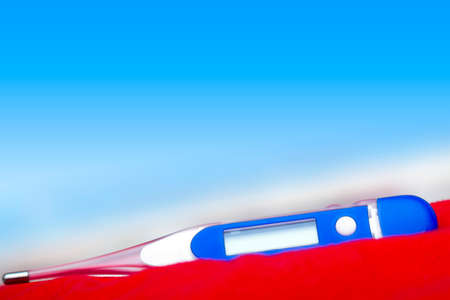 Electronic thermometer in a blue gradient background