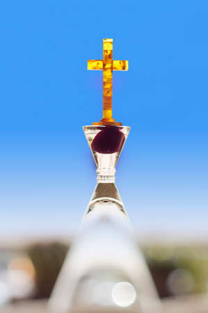 Amber cross in  a blurred bright backgroundの写真素材
