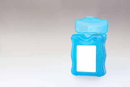 Dental floss in a grey grdient .