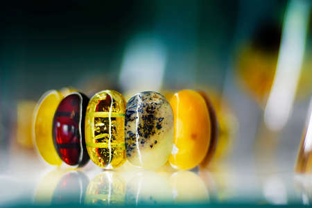 Amber bracelet on a glass in a blurry backgroundの写真素材